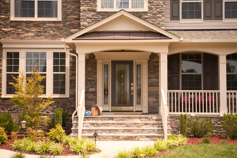 Stone home with covered porch and new doors and windows