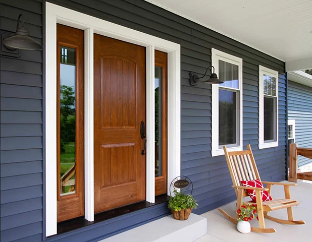 Blue home with rocking chair on porch